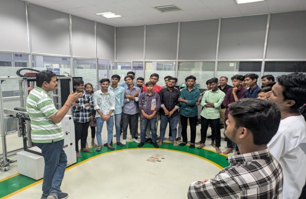 Students attending a training session on industrial equipment in a laboratory